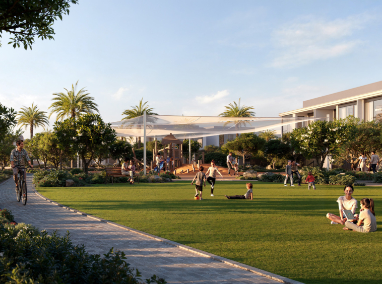 A family-friendly park with children playing, people cycling, and residents enjoying green open spaces at Greenspoint, Emaar South.3 & 4 Bedroom Townhouses at Greenspoint, Emaar South