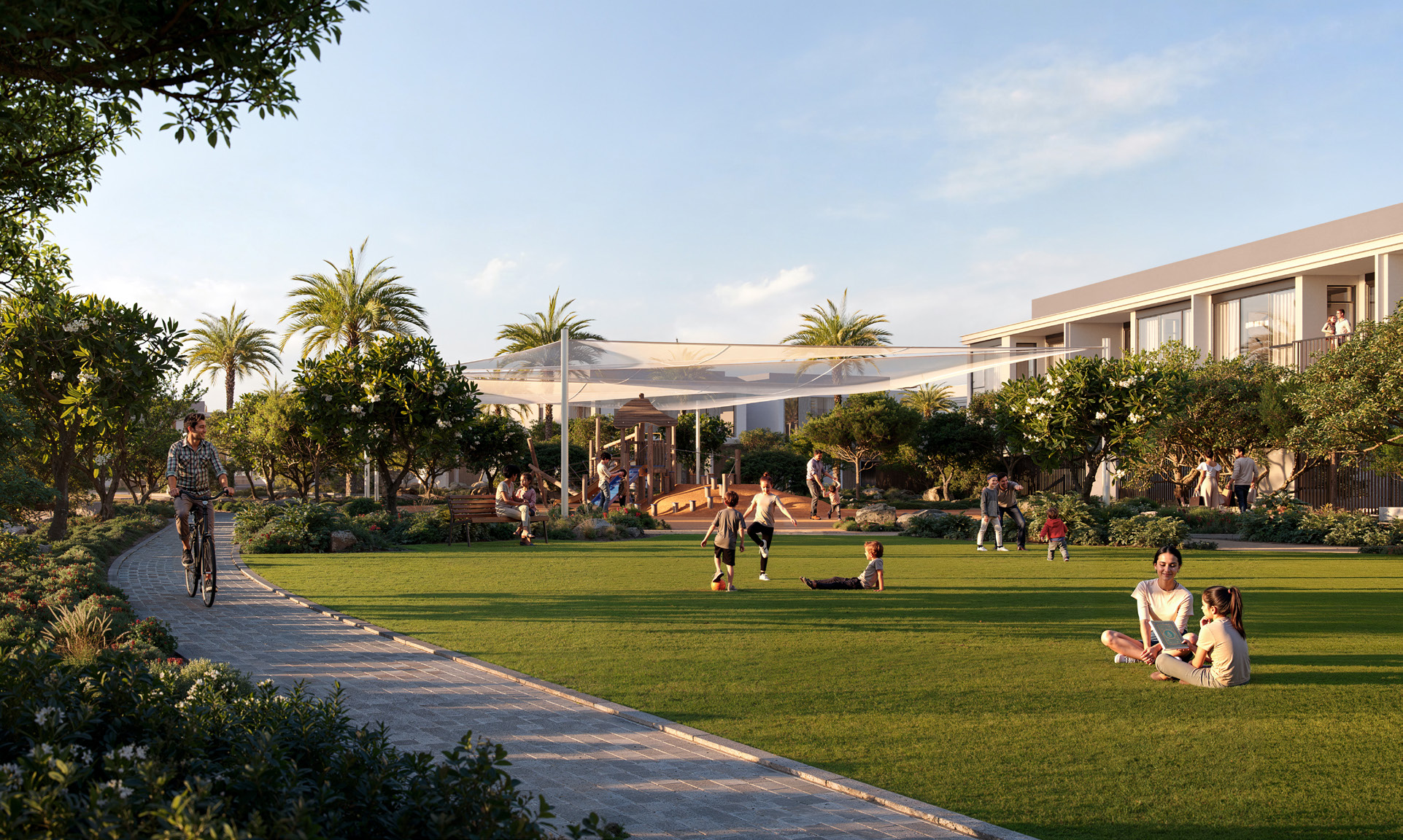 A family-friendly park with children playing, people cycling, and residents enjoying green open spaces at Greenspoint, Emaar South.3 & 4 Bedroom Townhouses at Greenspoint, Emaar South